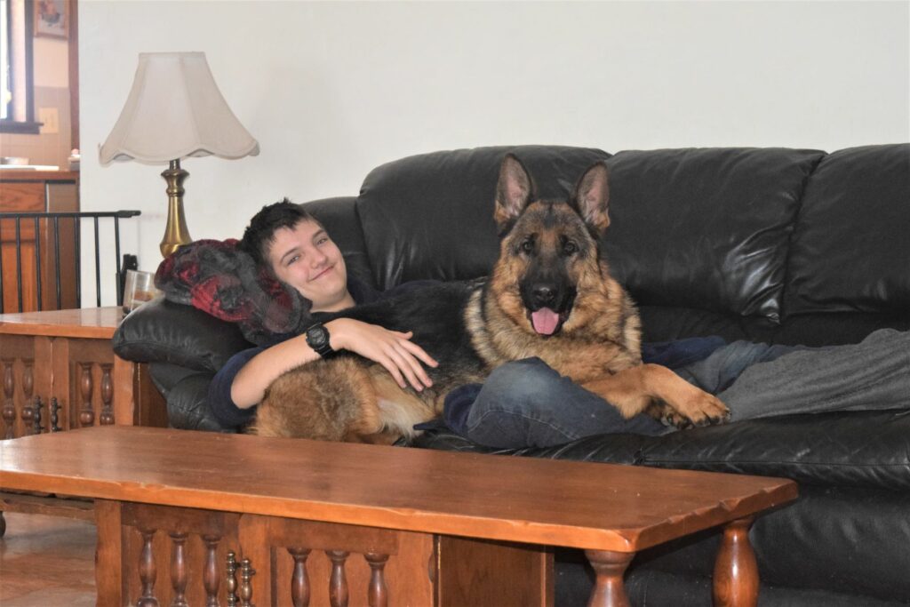 Trevor relaxing with his dog Lady.